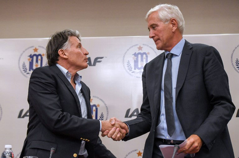 The president of the International Association of Athletics Federations (IAAF), Sebastian Coe (L), and the head of the IAAF's Russian taskforce team, Rune Andersen, shake hands after offering a press conference in the framework of the IAAF Council's Meeting in Buenos Aires, on July 27, 2018. PHOTO/AFP