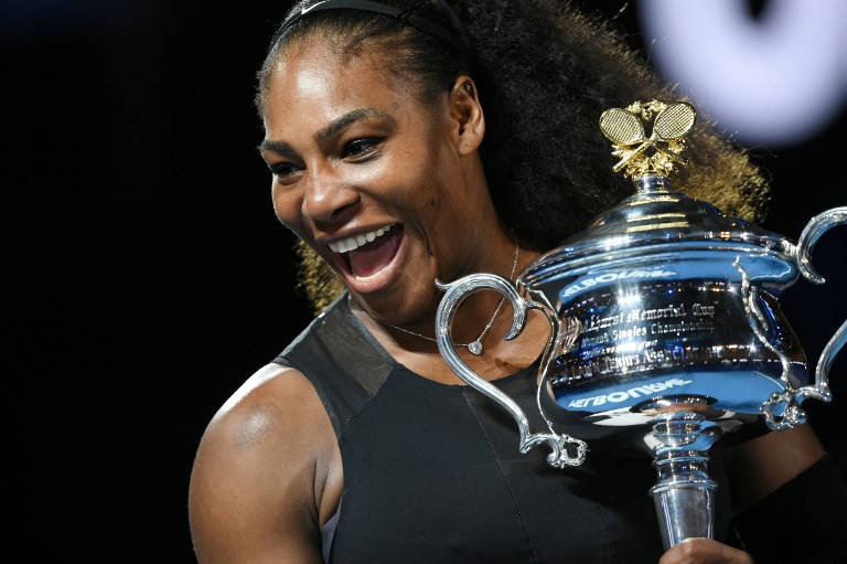 This file photo taken on January 28, 2017 shows Serena Williams of the US holding the winner's trophy following her victory over Venus Williams of the US in the women's singles final of the Australian Open tennis tournament in Melbourne. Seven times champion Serena Williams will be back at the Australian Open in 2019 having missed her title defence this year after giving birth, it was confirmed on October 9, 2018. PHOTO/AFP