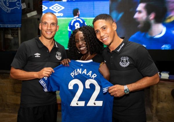 This lucky Kenyan lady Everton FC fan could not contain her joy after receiving a signed jersey from club legends, Leon Osman (left) and Steven Pienaar (right) during the launch of the Kenyan Toffees Supporters Club in Nairobi on Friday, July 5, 2019. PHOTO/SPN