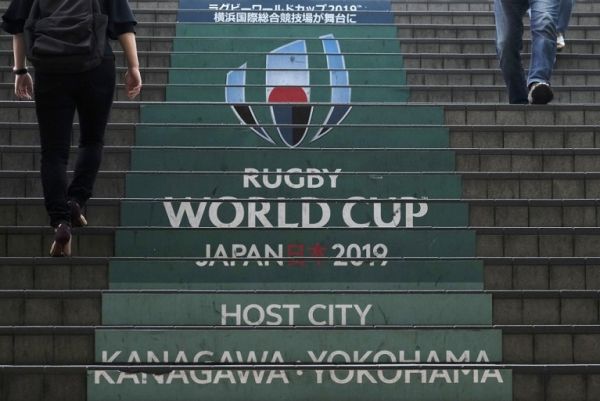 This picture taken on September 6, 2019 shows commuters walking down steps with the Rugby World Cup logo at an entrance of the Shin-Yokohama railway station in Yokohama, Kanagawa prefecture, a host city of the upcoming 2019 Rugby World Cup in Japan. PHOTO | AFP