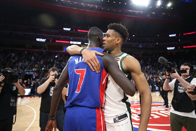 Thon Maker #7 of the Detroit Pistons and Giannis Antetokounmpo #34 of the Milwaukee Bucks hug after Game Four of Round One of the 2019 NBA Playoffs on April 22, 2019 at Little Caesars Arena in Detroit, Michigan.PHOTO/GETTY IMAGES