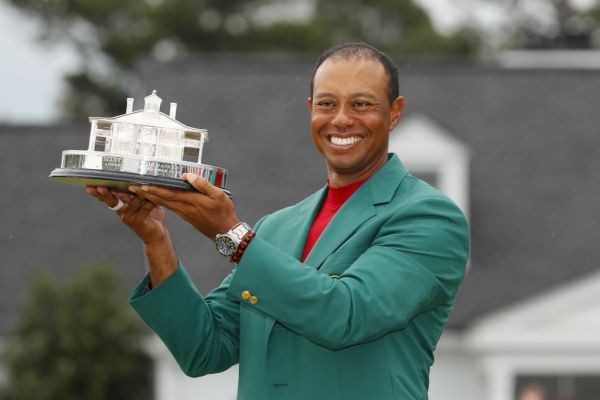 Tiger Woods of the United States celebrates with the Masters Trophy during the Green Jacket Ceremony after winning the Masters at Augusta National Golf Club on April 14, 2019 in Augusta, Georgia. PHOTO | AFP