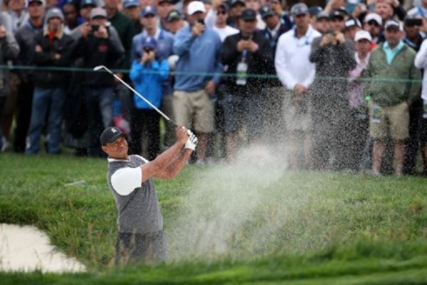 Tiger Woods of the United States plays a shot from a bunker on the 14th hole during the first round of the 2019 U.S. Open at Pebble Beach Golf Links on June 13, 2019 in Pebble Beach, California. PHOTO/ AFP