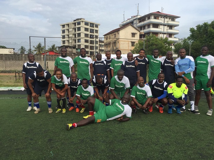 Tnazanian and Kenyan media teams pose for a photo before playing in a pre-SportPesa Cup friendly match at the Karume Grounds in Dar es Saalam, Tanzania. PHOTO/Courtesy