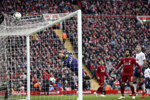 Tottenham Hotspur goalkeeper Hugo Lloris (1) pushes the ball onto the roof of the net with Liverpool forward Mohamed Salah (11) looking on during the Premier League match between Liverpool and Tottenham Hotspur at Anfield, Liverpool, England on 31 March 2019. PHOTO/AFP