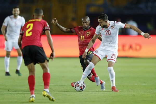 Tunisia's midfielder Ghaylen Chaalali (R) is marked by Angola's midfielder Hermenegildo da Costa 'Geraldo' Paulo Bartolomeu (2nd-R) during the 2019 Africa Cup of Nations (CAN) football match between Tunisia and Angola at the Suez Stadium in Suez on June 24, 2019. PHOTO | AFP