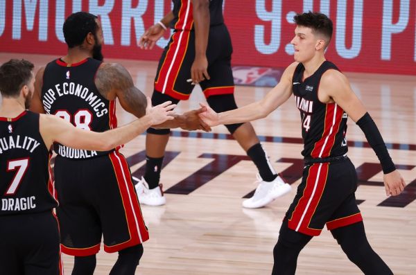 Tyler Herro #14 of the Miami Heat reacts with Andre Iguodala #28 of the Miami Heat and Goran Dragic #7 of the Miami Heat during the fourth quarter against the Boston Celtics in Game Four of the Eastern Conference Finals during the 2020 NBA Playoffs at AdventHealth Arena at the ESPN Wide World Of Sports Complex on September 23, 2020 in Lake Buena Vista, Florida. PHOTO | AFP