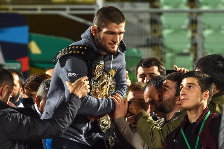 UFC lightweight champion Khabib Nurmagomedov of Russia carries his champions belt as he is escorted by fans upon the arrival in Makhachkala on October 8, 2018. Nurmagomedov defeated Conor McGregor of Ireland in their UFC lightweight championship bout by way of submission during the UFC 229 event inside T-Mobile Arena on October 6, 2018 in Las Vegas, Nevada. PHOTO/AFP