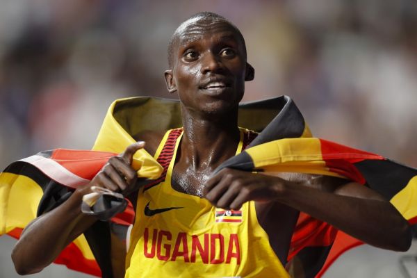 Uganda's Joshua Cheptegei holds the national flag after winning the Men's 10,000m final at the 2019 IAAF Athletics World Championships at the Khalifa International stadium in Doha on October 6, 2019. PHOTO | AFP