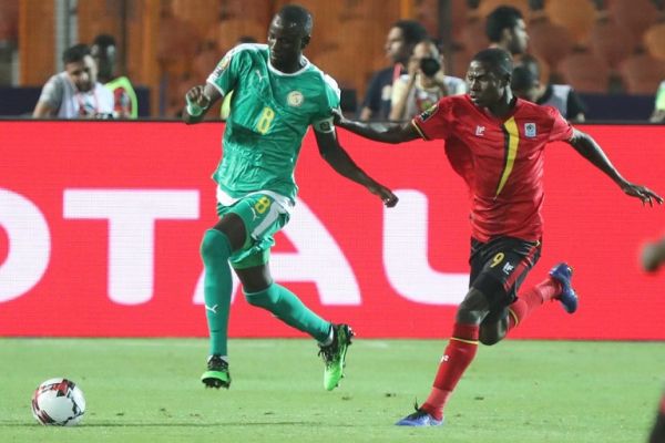 Uganda's Patrick Kaddu (R) and Senegal's Cheikhou Kouyate battle for the ball during the 2019 Africa Cup of Nations round of 16 soccer match between Uganda and Senegal at Cairo International Stadium. PHOTO | AFP