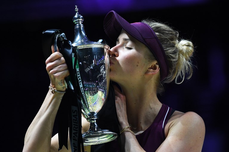 Ukraine's Elina Svitolina kisses her winning trophy after defeating Sloane Stephens of the US in their singles final match at the WTA Finals tennis tournament in Singapore on October 28, 2018. PHOTO/AFP