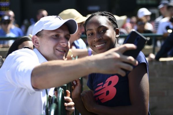 US player Cori Gauff (R) poses for a selfie with fans after a session on the practice courts at The All England Tennis Club in Wimbledon, southwest London, on July 4, 2019, on the fourth day of the 2019 Wimbledon Championships tennis tournament. PHOTO/AFP