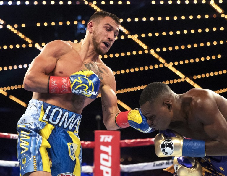 Vasiliy Lomachenko (L) punches Guillermo Rigondeaux during their WBO Junior Lightweight Title bout at Madison Square Garden in New York City. PHOTO/AFP
