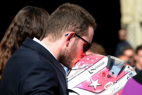 Victhor, brother of the late French racing driver Anthoine Hubert kisses his helmet at the end of the funeral ceremony in the Cathedral of Notre Dame, on September 10, 2019, in Chartres, center France. The 22-year-old F2 driver was killed on August 31, 2019 in a crash on the Spa-Francorchamps circuit. PHOTO | AFP