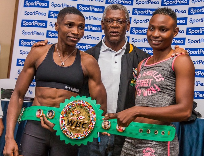 WBC women Super bantamweight champion, Fatuma 'Iron Fist' Zarika (left) and WBC Supervisor Dr. Peter Ngatane and challenger Catherine Phiri (right) pose during the weigh in of their title fight on March 22, 2019. PHOTO/Brian Kinyanjui