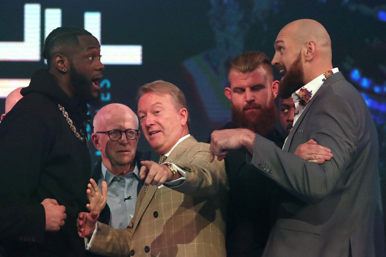 WBC world heavyweight champion, US boxer Deontay Wilder (L), and former world heavyweight champion, British boxer Tyson Fury (R) are seperated by boxing promoter and manager Frank Warren (C) during a press conference in London on October 1, 2018 ahead of their scheduled title fight on December 1. PHOTO/AFP