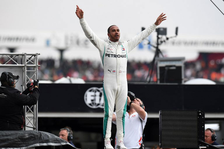Winner Mercedes' British driver Lewis Hamilton celebrates after the German Formula One Grand Prix at the Hockenheim racing circuit on July 22, 2018 in Hockenheim, southern Germany. PHOTO/AFP