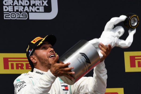 Winner Mercedes' British driver Lewis Hamilton celebrates with his trophy on the podium after the Formula One Grand Prix de France at the Circuit Paul Ricard in Le Castellet, southern France, on June 23, 2019. PHOTO/AFP