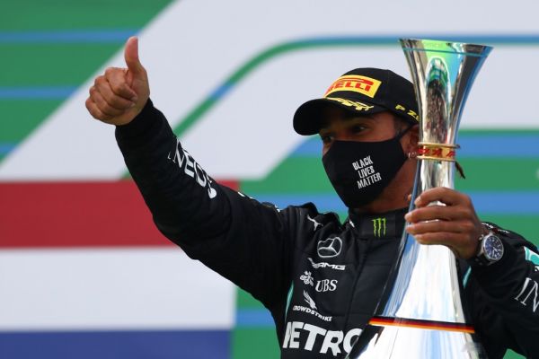 Winner Mercedes' British driver Lewis Hamilton celebrates with his trophy on the podium after the German Formula One Eifel Grand Prix at the Nuerburgring circuit in Nuerburg, western Germany, on October 11, 2020. PHOTO | AFP