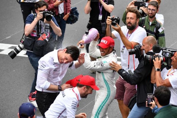 Winner Mercedes' British driver Lewis Hamilton spills champagne over Mercedes AMG Petronas F1 Team's team principal Toto Wolff (L) after the Monaco Formula 1 Grand Prix at the Monaco street circuit on May 26, 2019 in Monaco. PHOTO | AFP
