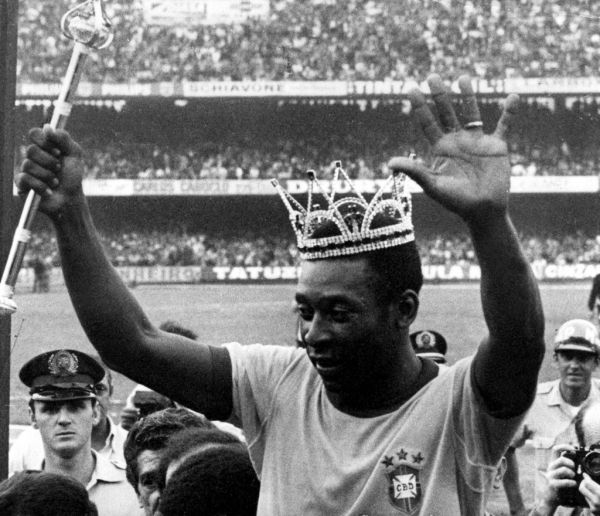 With crown on the head and holding a scepter, Pelé waves to audience as he leaves the field after farewell match, in São Paulo, southeastern Brazil, July 11, 1971. At game held at Morumbi Stadium, Brazil defeated Austria 1-0. PHOTO | AFP