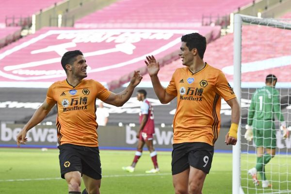 Wolverhampton Wanderers' Mexican striker Raul Jimenez (R) celebrates scoring the opening goal with Wolverhampton Wanderers' Portuguese midfielder Pedro Neto (L) during the English Premier League football match between West Ham United and Wolverhampton Wanderers at The London Stadium, in east London on June 20, 2020. PHOTO | AFP