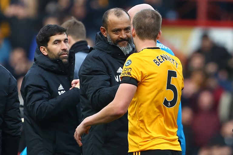 Wolverhampton Wanderers' Portuguese head coach Nuno Espirito Santo congratulates Wolverhampton Wanderers' English defender Ryan Bennett (R) on the pitch after the English FA Cup fifth round football match between Bristol City and Wolverhampton Wanderers at Ashton Gate Stadium in Bristol, south-west England on February 17, 2019. Wolves won the game 1-0. PHOTO/AFP