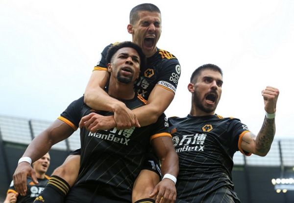 Wolverhampton Wanderers' Spanish striker Adama Traore (L) celebrates scoring the opening goal with Wolverhampton Wanderers' English defender Conor Coady during the English Premier League football match between Manchester City and Wolverhampton Wanderers at the Etihad Stadium in Manchester, north west England, on October 6, 2019. PHOTO | AFP