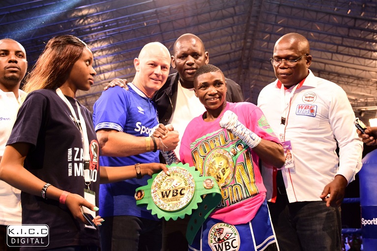 World Boxing Council (WBC) Women Super Bantamweight champion,Fatuma ‘Iron Fist’ Zarika , celebrates her second successful title defence with Jakob Kristensen, Global Chief Operations Officer, SportPesa (blue top) and Kenya Professional Boxing Commission Vice Chairman, George Adipo (right) at the KICC in Nairobi on September 8, 2018.PHOTO/SPN