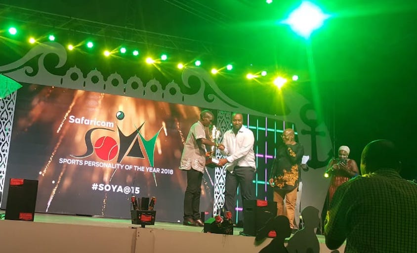 World marathon record holder, Eliud Kipchoge (left) receives the 2018 Male Sports Personality of the Year trophy from Mombasa Governor Hassan Ali Joho (centre) at the Safaricom Sports Personality of the Year Awards held at the Fort Jesus on Friday, January 11, 2018. PHOTO/Courtesy/Capital FM 